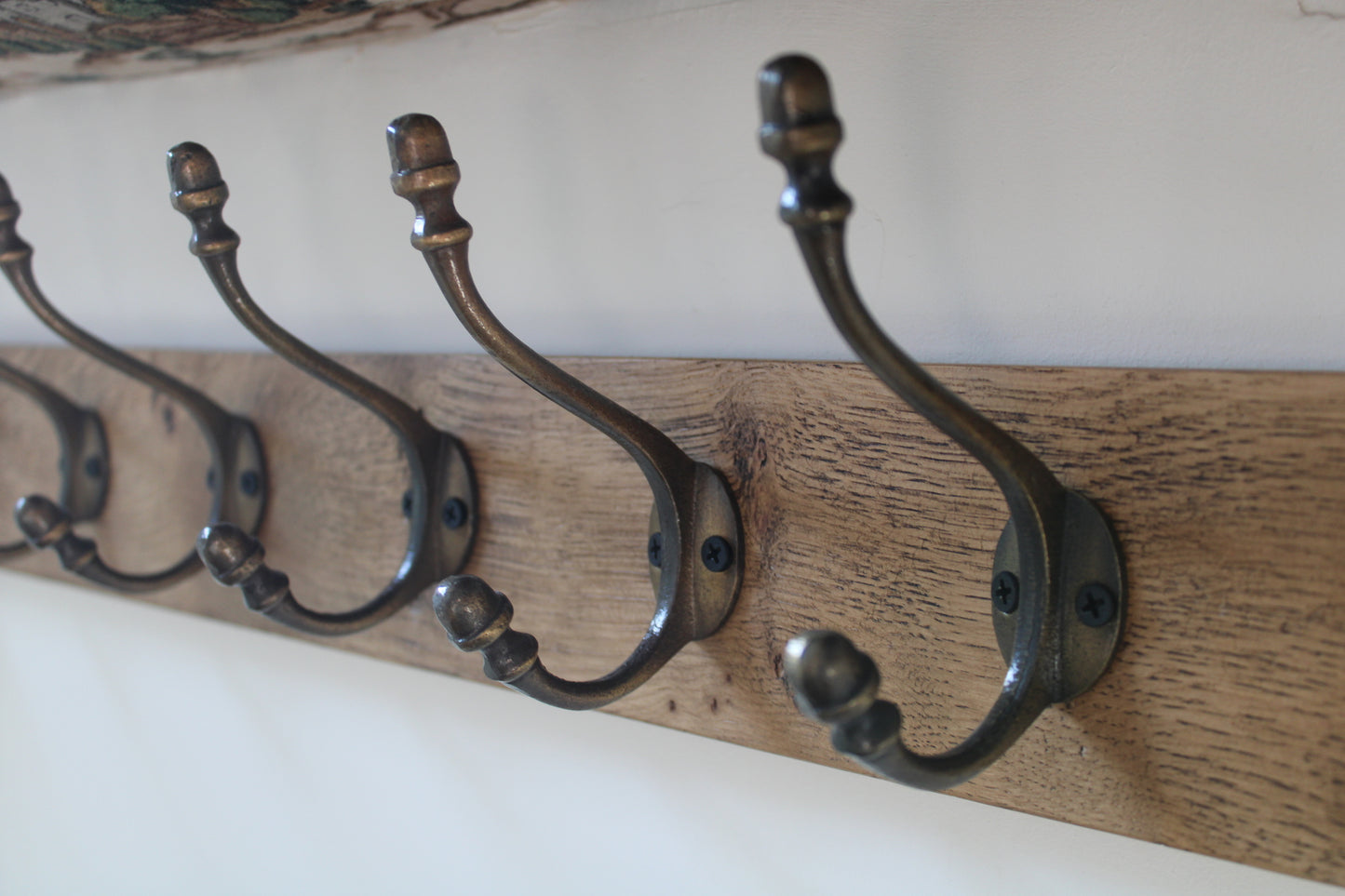 Wall mounted Oak Coat Rack with Antique Style Cast Iron Hooks with Acorn head detail.