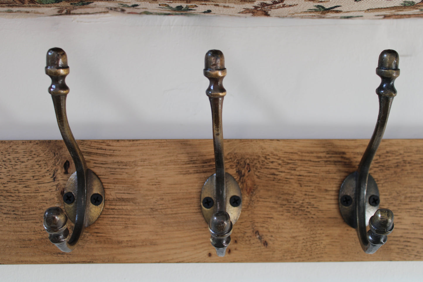 Wall mounted Oak Coat Rack with Antique Style Cast Iron Hooks with Acorn head detail.